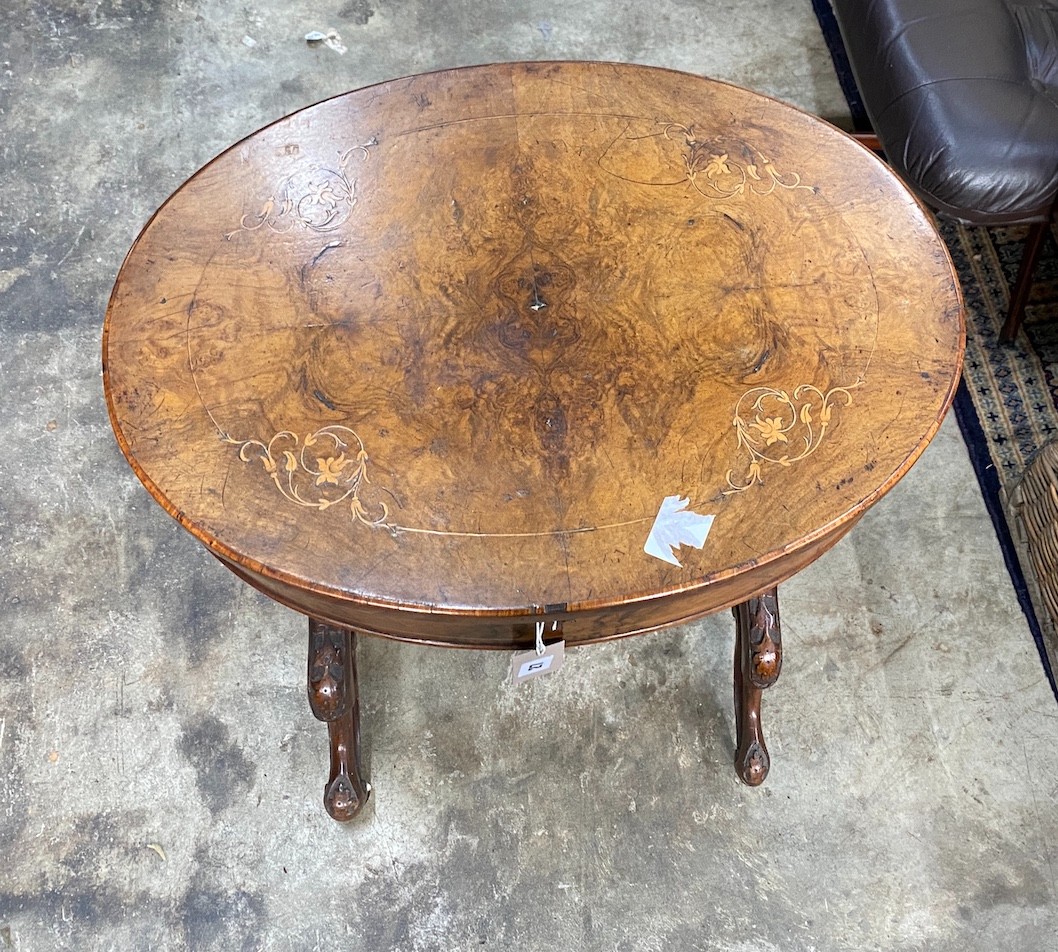 A Victorian oval marquetry inlaid walnut work table (missing basket), width 56cm, depth 42cm, height 71cm